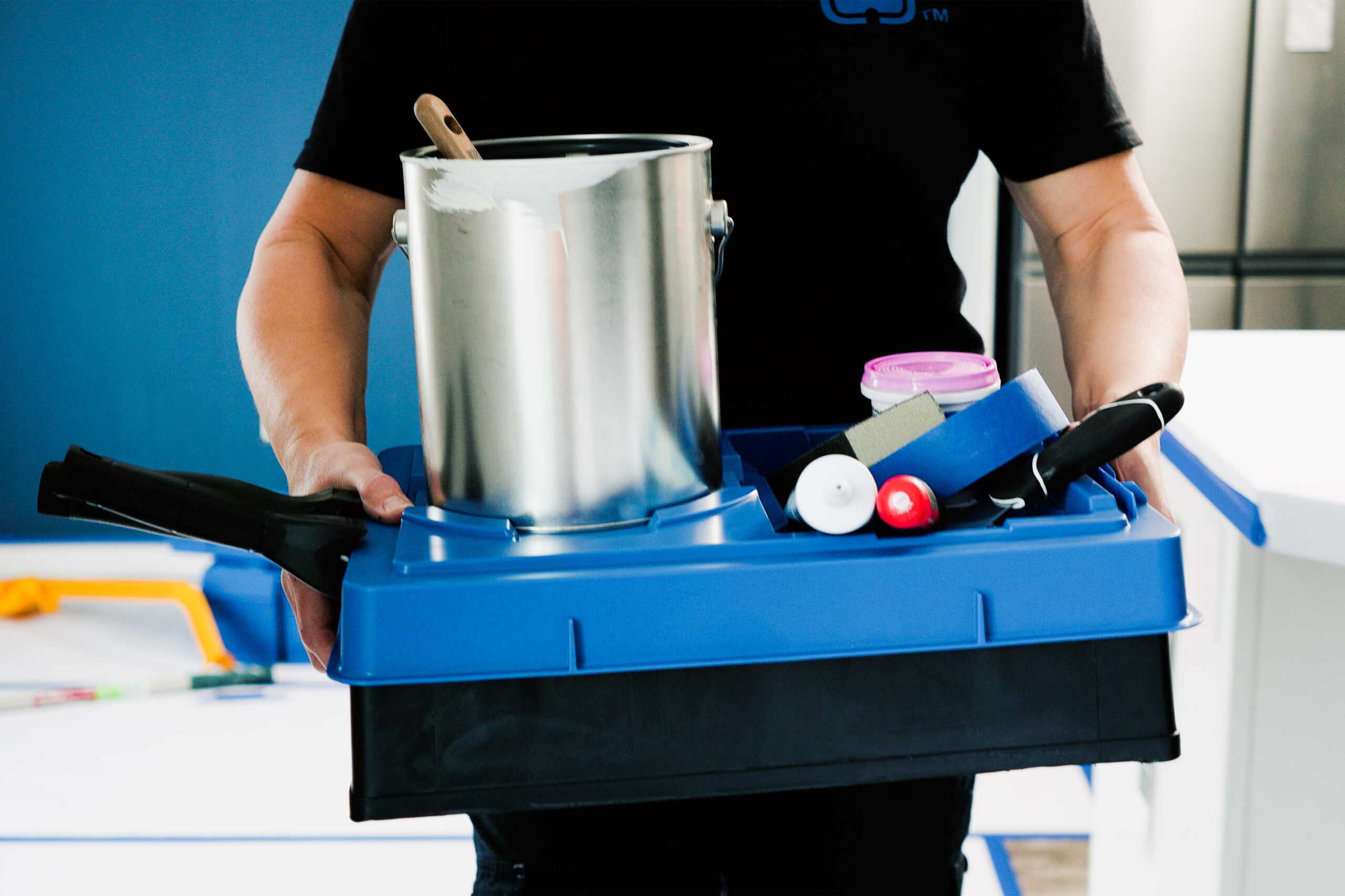 Blue-PALOT-TRAY-PAL-Carrying-Next-Room Karen Wolfe carries a paint tray with a blue PALOT Tray Pal lid and all of her painting supplies neatly collected on top.
